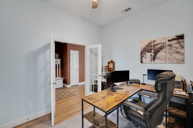 Home office with french doors, wood finished floors, and a ceiling fan | Image 20