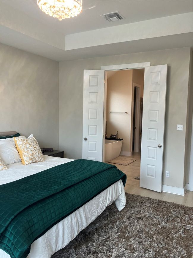 Bedroom featuring a chandelier and baseboards | Image 10