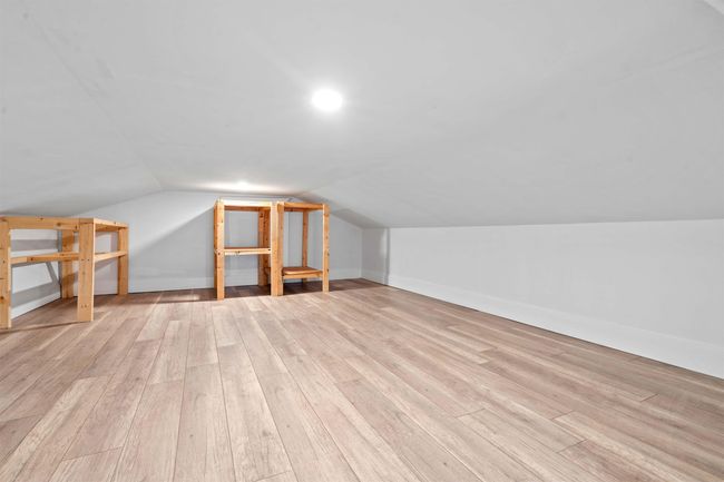 Additional living space with wood finished floors, lofted ceiling, and baseboards | Image 22