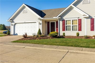 Ranch-style house featuring a garage and a front lawn | Image 2