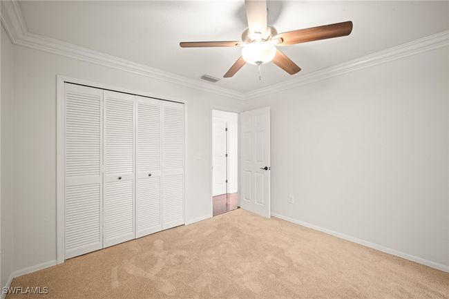 Unfurnished bedroom with carpet, ornamental molding, a closet, and ceiling fan | Image 22