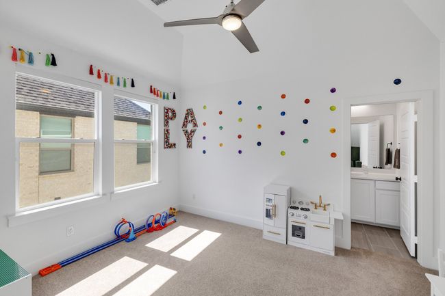 Game room with light colored carpet, a ceiling fan, baseboards, and lofted ceiling | Image 29