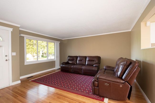 Living room featuring wood finished floors and ornamental molding | Image 4