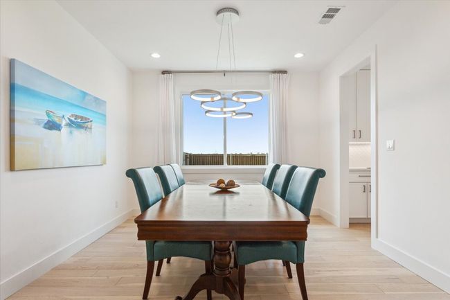 Dining space featuring a chandelier, light wood-type flooring, baseboards, and recessed lighting | Image 8