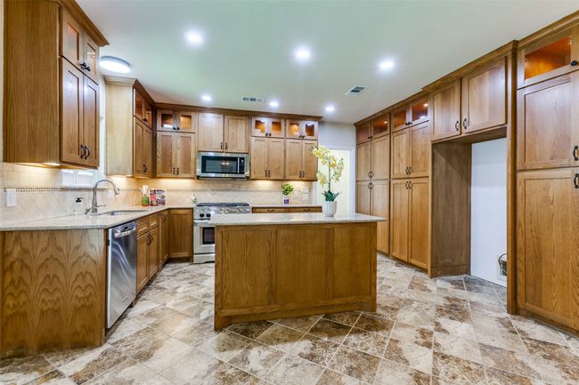 Top of the line Kitchenaid appliance package, with a 36" gas range, tons of counter space and great lighting will delight the chef in your family! | Image 11