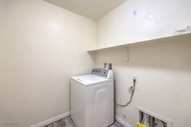 Laundry area featuring baseboards, washer / clothes dryer, light wood-style flooring, and laundry area | Image 26