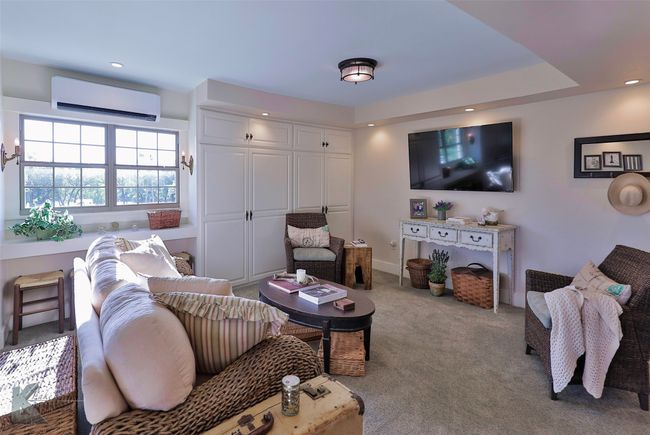 Living area featuring an AC wall unit, carpet, and recessed lighting | Image 14