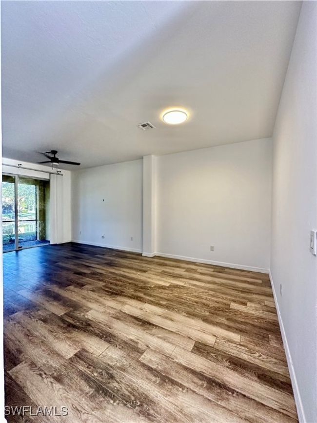 Unfurnished room with hardwood / wood-style flooring and ceiling fan | Image 6