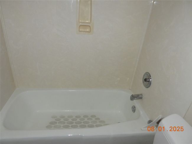 Bathroom with tub / shower combination and toilet | Image 10