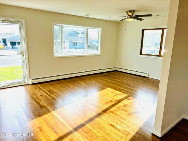 Welcome! Freshly painted and refinished hardwood flooring throughout the home. | Image 4