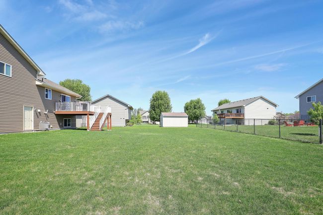 The home sits on a spacious yard, offering plenty of room for outdoor activities, gardening, or simply enjoying the open space. | Image 36