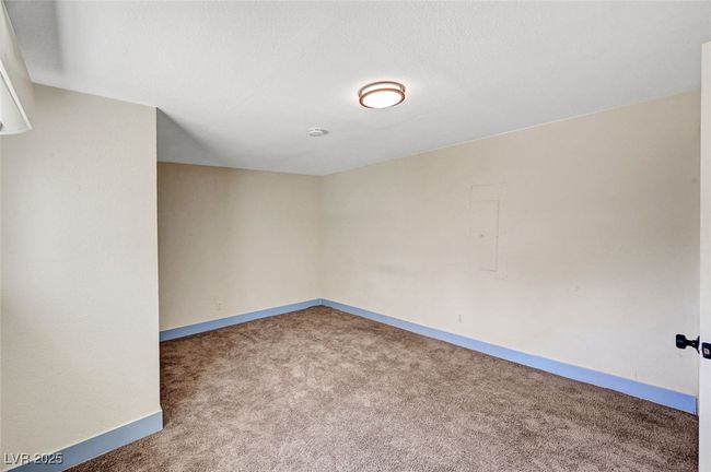 Carpeted spare room featuring baseboards and electric panel | Image 35