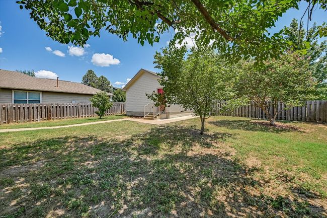 View of fenced backyard | Image 29