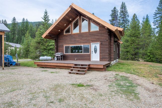 Back of property featuring log exterior, a forest view, and a deck | Image 57