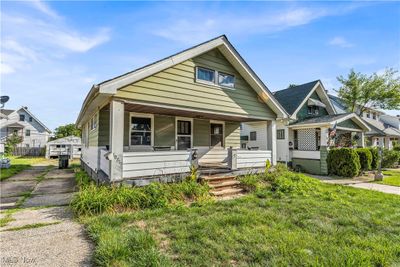 Bungalow-style home with a front yard and covered porch | Image 2