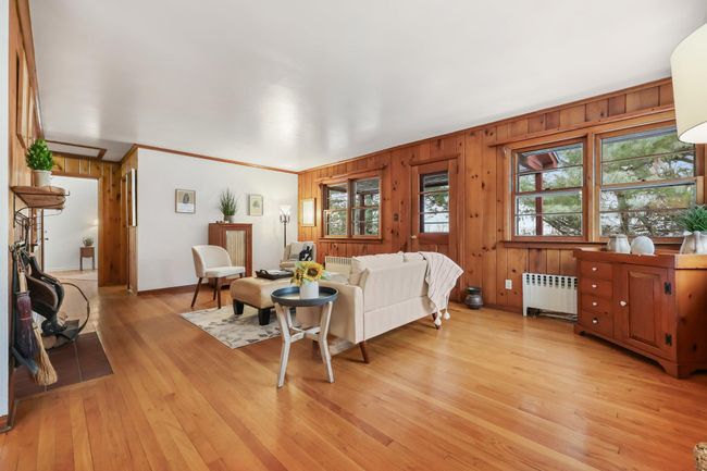 Living room views wall of windows and door to back porch | Image 9