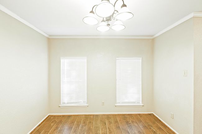 Unfurnished room featuring a chandelier, hardwood / wood-style floors, and ornamental molding | Image 8