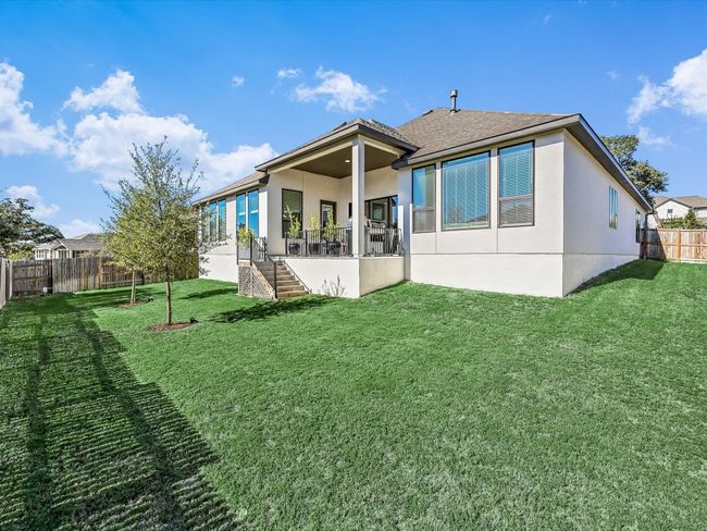 Rear view of property with stucco siding, a fenced backyard, and stairway | Image 34