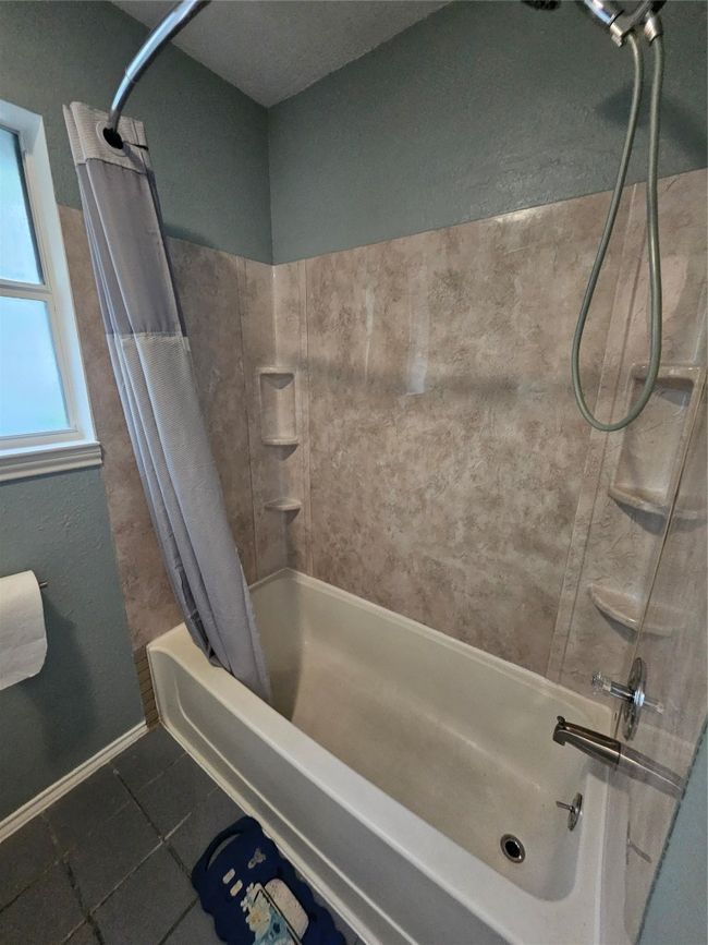 Full bath featuring shower / bathtub combination with curtain and tile patterned floors | Image 25