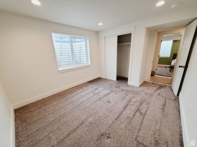 Unfurnished bedroom featuring carpet, baseboards, a closet, and recessed lighting | Image 26