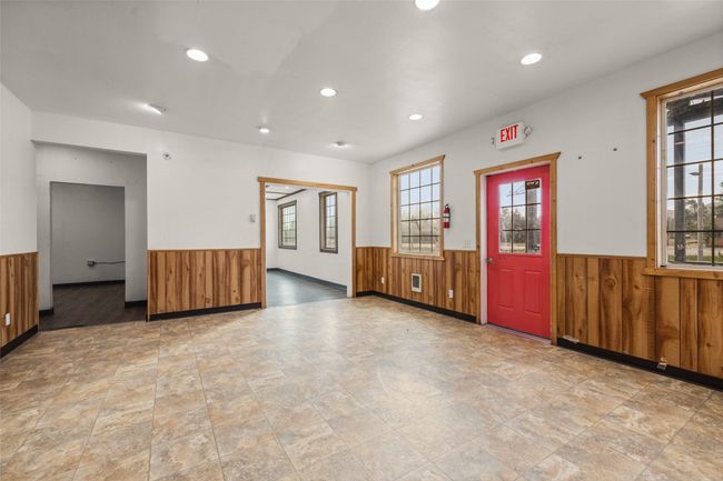 Empty room featuring wainscoting, wood walls, recessed lighting, and stone finish flooring | Image 59