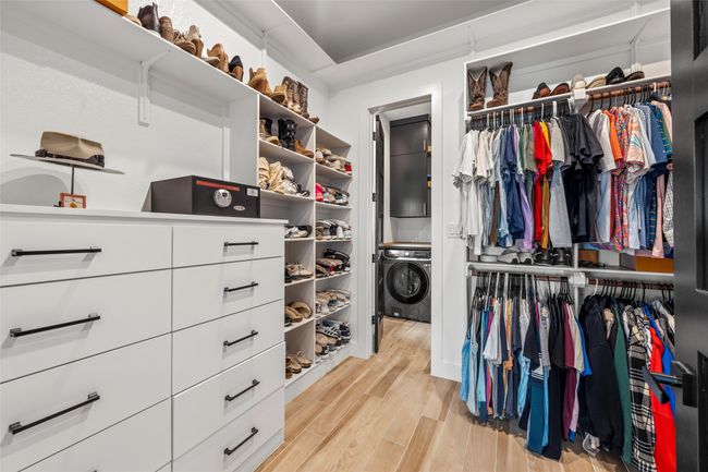 Walk in closet with light wood-style floors | Image 27