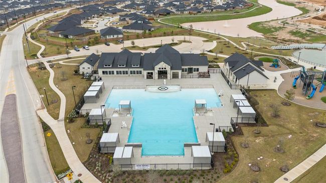 In addition to the variety of pools, the neighborhood also features a pool with a gradual depth entrance, designed for easy access without steps. This gentle slope makes it ideal for those who prefer a more gradual entry into the water, providing a safe and relaxing experience for all ages. Whether it's for a comfortable swim or simply enjoying the water at your own pace, this pool adds another layer of convenience and accessibility to the community's aquatic amenities. | Image 25