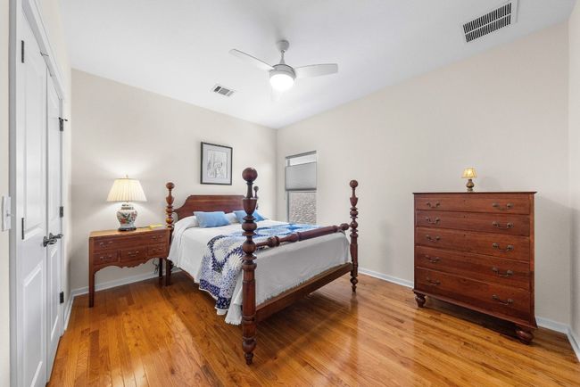 Bedroom featuring visible vents, light wood finished floors, and baseboards | Image 26