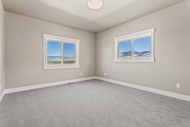 Spare room featuring healthy amount of natural light, carpet flooring, and baseboards | Image 26