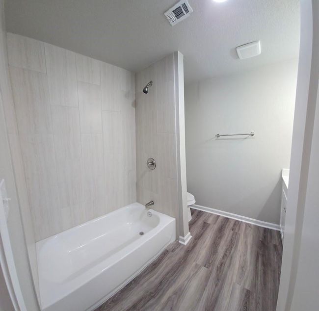 The spacious hall bath includes a newly tiled tub/shower combo | Image 13