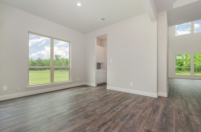 Spare room featuring dark wood-type flooring, baseboards, and recessed lighting | Image 25