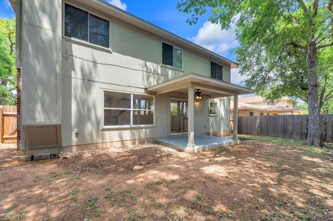 Rear view of property with fence, a patio area, and ceiling fan | Image 33