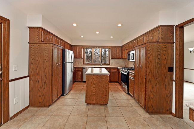 Freshly Painted Large Updated Kitchen Features Center Island, Loads of Storage with Screen Porch through Sliders. All Appliances Stay! | Image 23