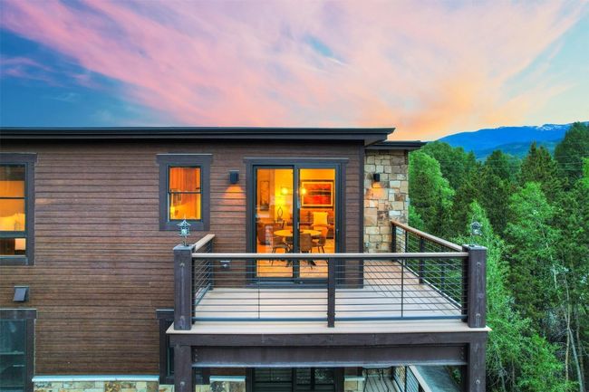 View of front facade with a mountain view, stone siding, and a balcony | Image 31