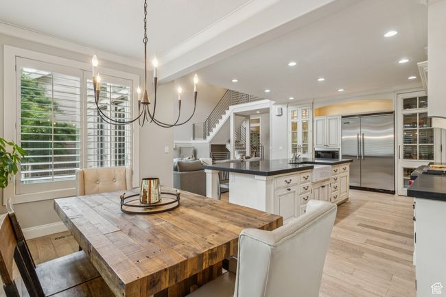 Dining area with crown molding, recessed lighting, light wood finished floors, plenty of natural light, and stairs | Image 20