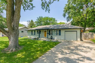 Ranch-style house with a garage and a front yard | Image 2