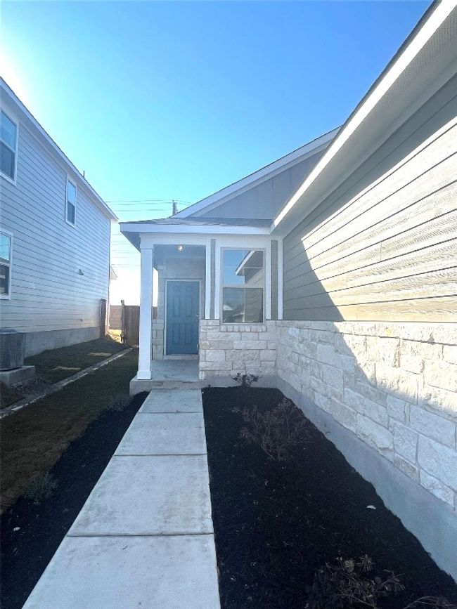 Doorway to property featuring stone siding | Image 5