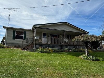 You cant' tell from this picture but this home sits above Ziegler Rd. Nice landscaping. | Image 1