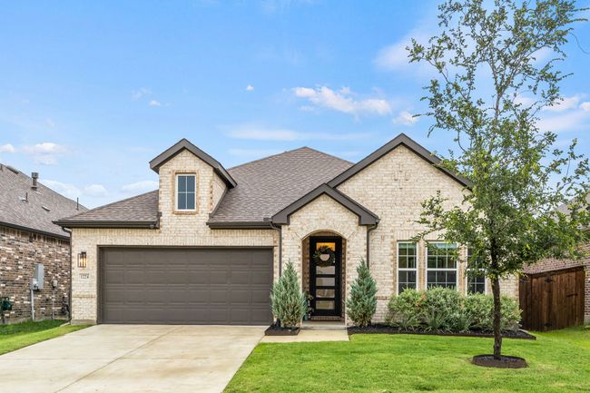 French provincial home with a shingled roof, a garage, brick siding, and concrete driveway | Image 20