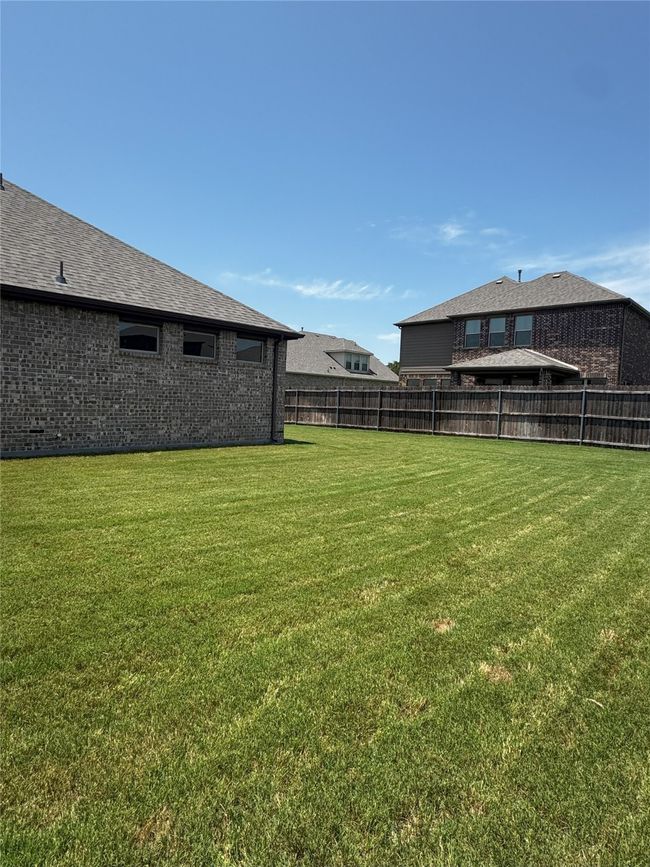View of fenced backyard | Image 29