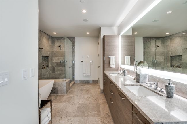 Bathroom with a freestanding tub, double vanity, a shower stall, and recessed lighting | Image 19