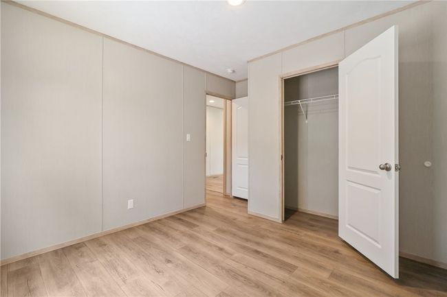 Unfurnished bedroom featuring baseboards and light wood-style floors | Image 15