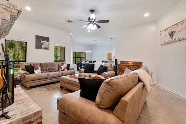 Living area with recessed lighting, visible vents, crown molding, and ceiling fan with notable chandelier | Image 6