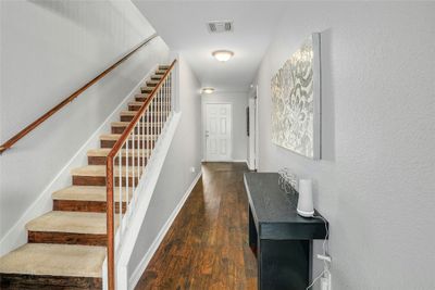 Gorgeous foyer that has stairs in the back of the house that opens to the family living and kitchen. Study is located on the right of the front door. | Image 3