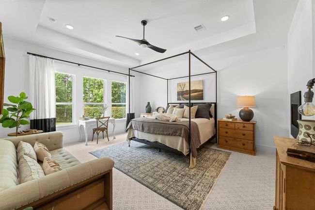 Elegant primary suite with beautiful views of the private backyard. | Image 26