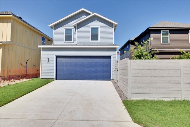 Traditional-style house with an attached garage, driveway, and fence | Image 29