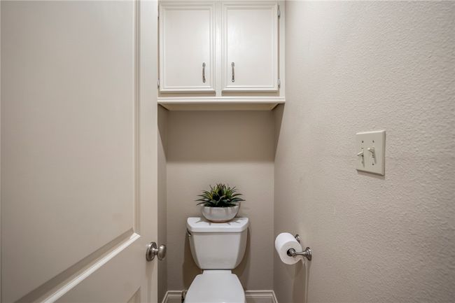 Bathroom featuring a textured wall and toilet | Image 39
