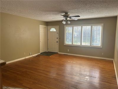 Foyer featuring a textured ceiling, hardwood / wood-style flooring, and ceiling fan | Image 3