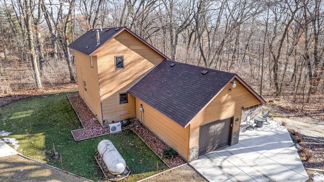 Aerial view of the main home. For those seeking a private oasis with proximity to city amenities, this property is the perfect home. Embrace the tranquility and convenience of this unique and well-appointed home & out buildings. | Image 38
