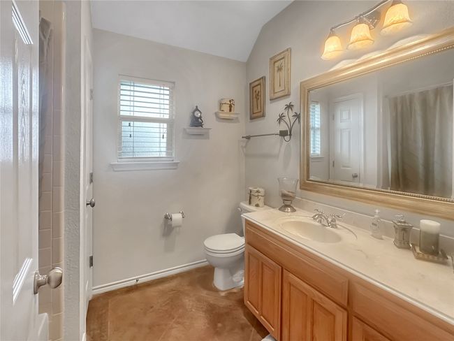 Bathroom featuring vaulted ceiling, toilet, vanity, baseboards, and a shower with curtain | Image 13